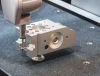 CMM inspection machine measuring a CNC machined metal part