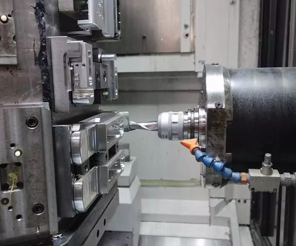 Horizontal CNC machining center machining a metal housing
